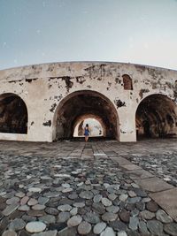 People walking on archway of building