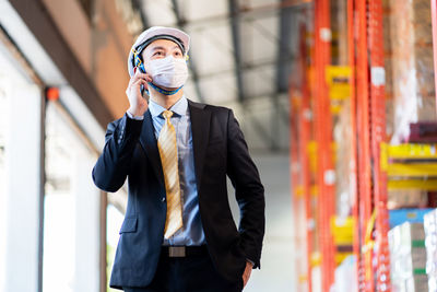 Young man standing in front of built structure