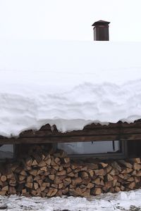 Stack of logs against sky