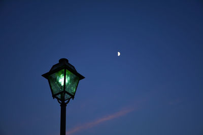 Low angle view of street light against blue sky