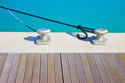 High angle view of rope on pier against sea