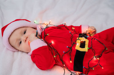 High angle view of cute baby girl sleeping on bed