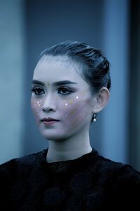 Close-up of woman with face paint standing outdoors