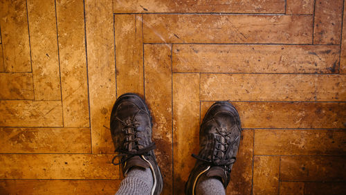 Low section of person standing on floorboard