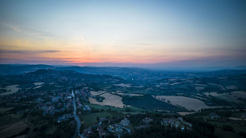 Aerial view of townscape against sky during sunset