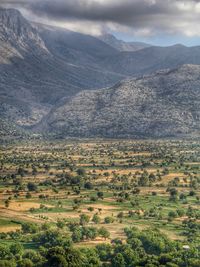 Scenic view of mountains against cloudy sky