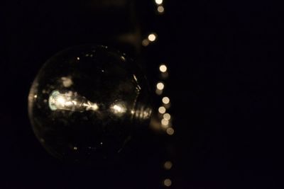 Close-up of light bulb at night