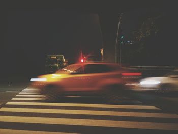 Cars on illuminated street at night