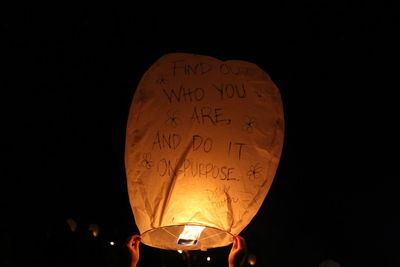 Close-up of illuminated lantern against black background