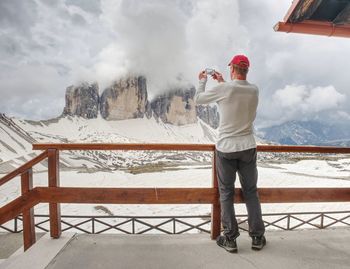 Man trekking in the alps. mountain ridge view of tre cime di lavaredo, national park. italy