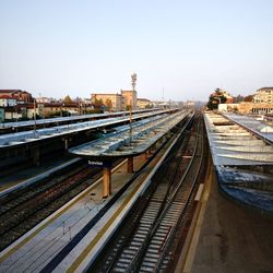 High angle view of railroad tracks in city against clear sky