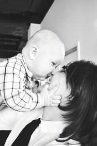 Close-up of mother holding baby at home