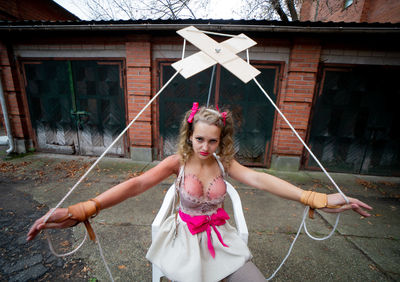 Portrait of young woman holding umbrella