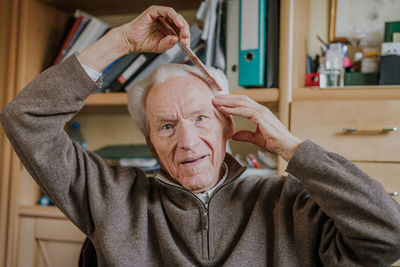 Portrait of man wearing mask at home