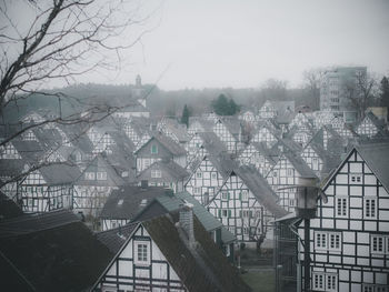 Buildings in city against sky during winter