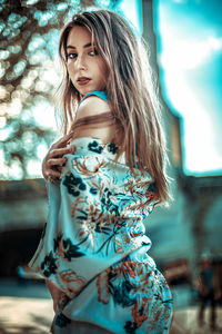 Portrait of young woman wearing mask outdoors