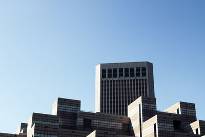 Low angle view of modern buildings against clear sky