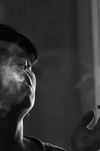 Close-up portrait of man smoking cigarette