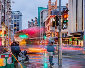 Blurred motion of people walking on city street