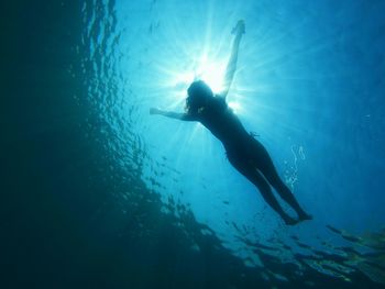 Low angle view of woman swimming in sea