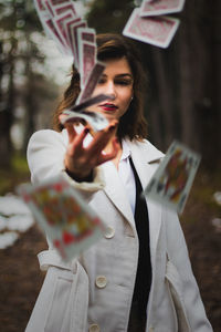 Young woman looking at camera while standing outdoors