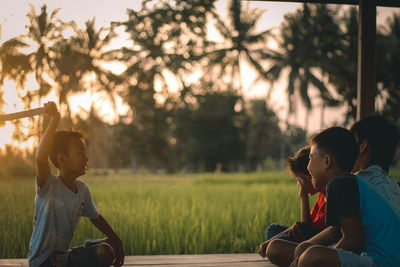 Rear view of couple sitting on land