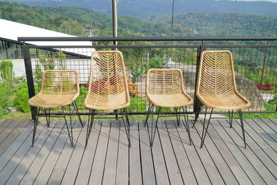 Empty chairs and table against sky