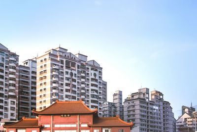 Low angle view of buildings against clear blue sky