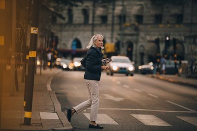 Woman standing on street in city