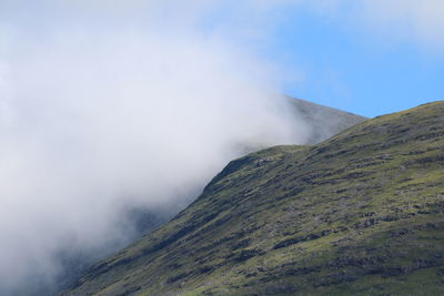 Scenic view of mountains among the clouds