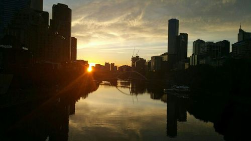 Buildings in city at sunset