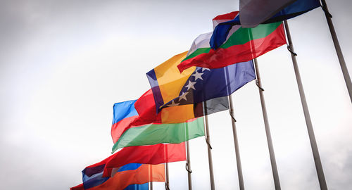 Low angle view of flag flags against sky