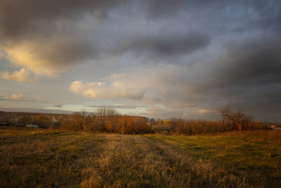 Scenic view of field against sky during sunset