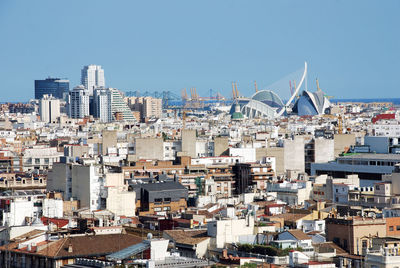 Aerial view of townscape against clear blue sky