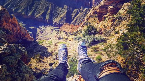 Low section of person standing on rock