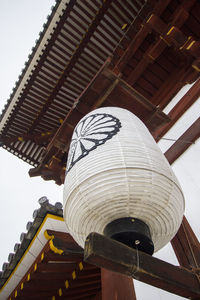 Low angle view of lantern hanging outside building