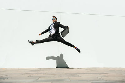 Low angle view of man jumping at beach