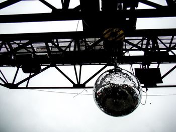 Low angle view of illuminated light bulb against sky