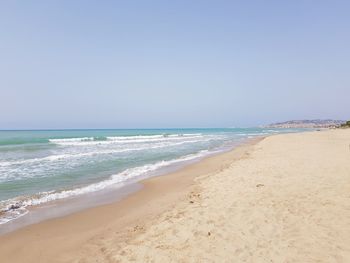 Scenic view of beach against clear sky