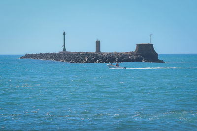 Scenic view of sea against clear blue sky