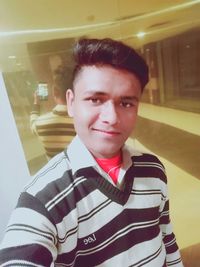 Portrait of smiling boy standing in office