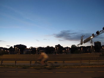 Blurred motion of vehicles on road against sky