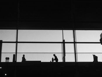 Low angle view of silhouette men at charles de gaulle airport