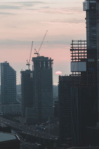 Buildings against sky at sunset