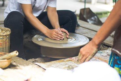 Thai women using mechanic pottery practice sculpt earthenware at koh kret, bangkok thailand