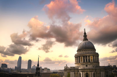 Buildings in city against sky during sunset