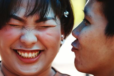 Close-up of woman kissing friend