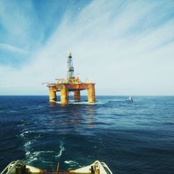 Oil platform at sea against sky