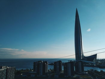 Modern buildings in city against blue sky