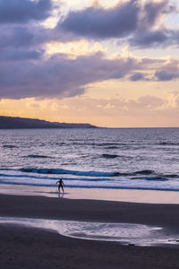 Man exercising surf at sunset on the las canteras beach in las palmas